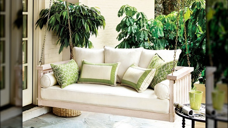 White porch swing with cushions