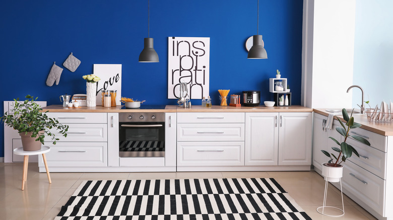 bold blue wall behind cabinets