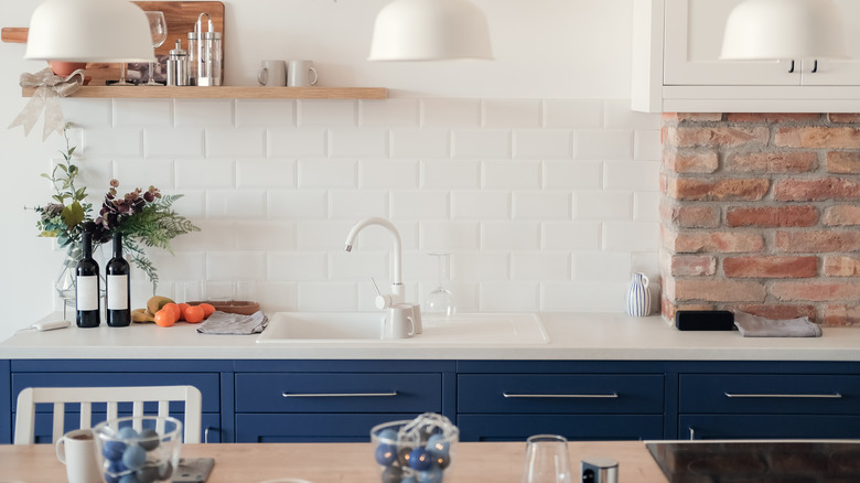 brick wall with blue cabinets