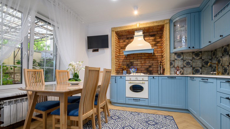 blue cabinets with wooden furniture