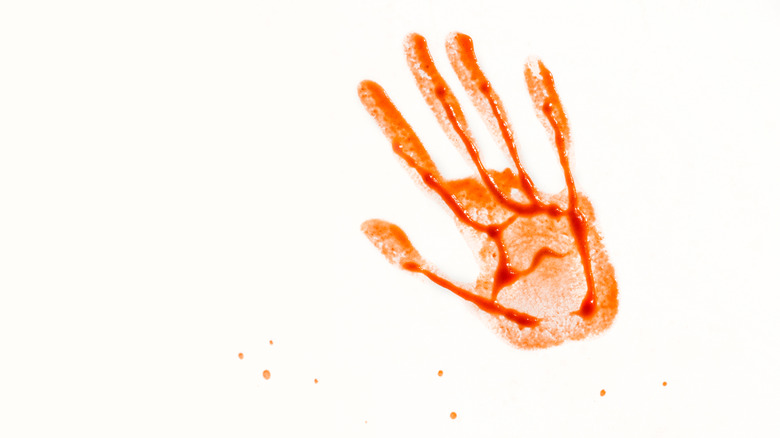 red handprint on white background