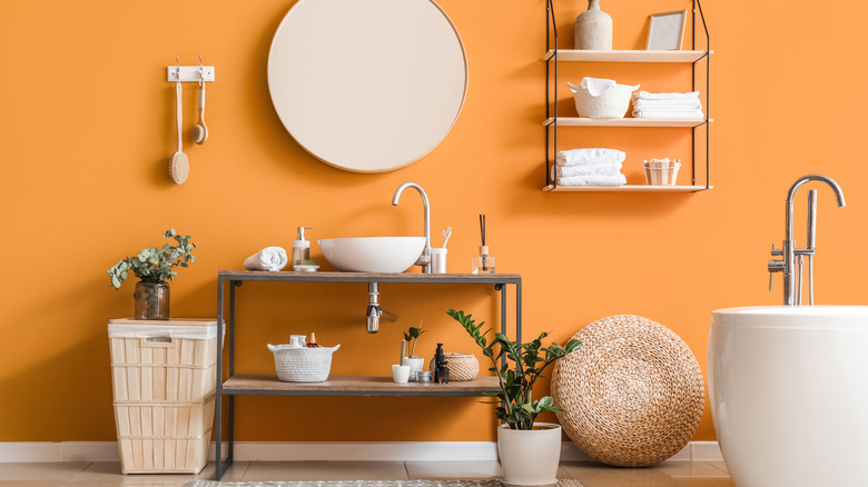orange bathroom with rustic countertop