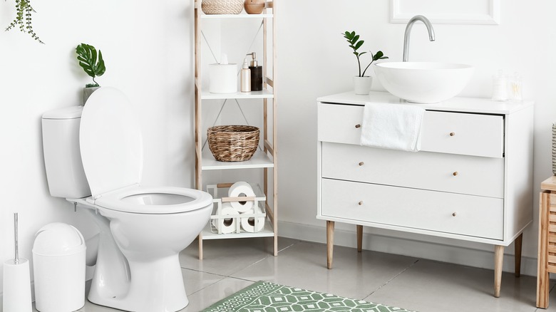 white bathroom with dresser vanity 