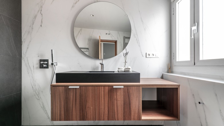 modern bathroom with circular mirror