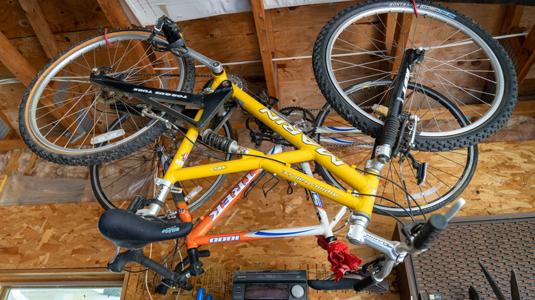 two bikes hanging from ceiling