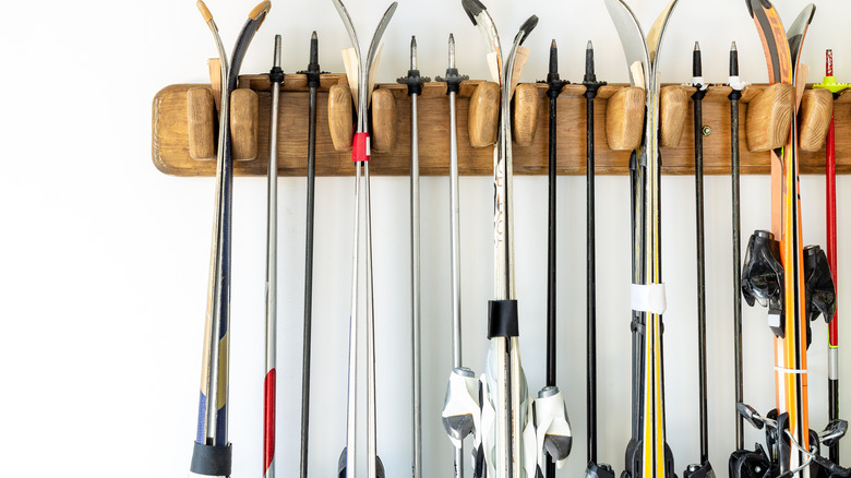 skis hanging on wooden hanger