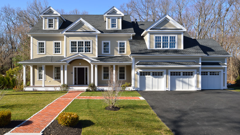 asphalt driveway with brick walkway