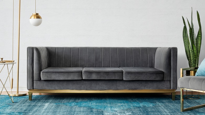 Charcoal sofa on teal rug