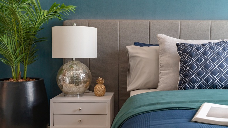 Teal bedroom with navy pillow