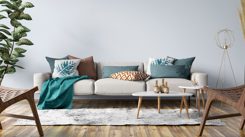 Neutral sofa with teal pillows