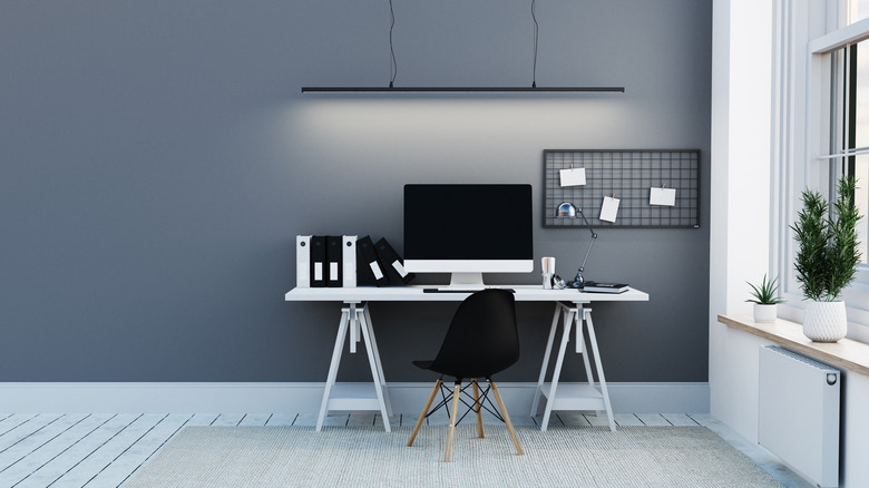 blue-gray wall behind desk