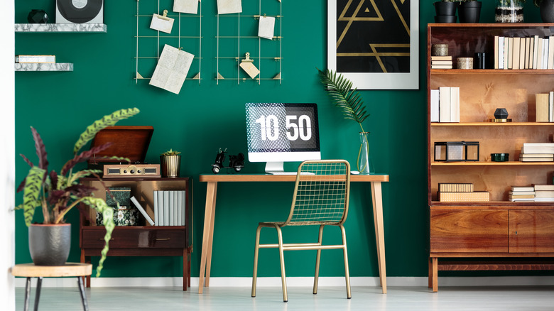 emerald green wall behind desk