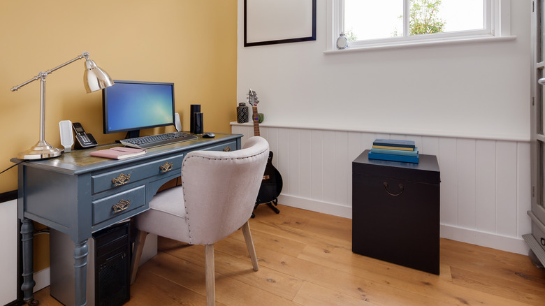 mustard yellow wall behind desk