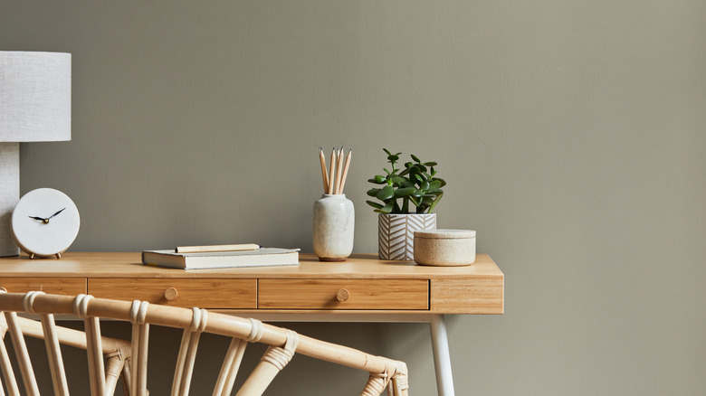 muted green wall behind desk