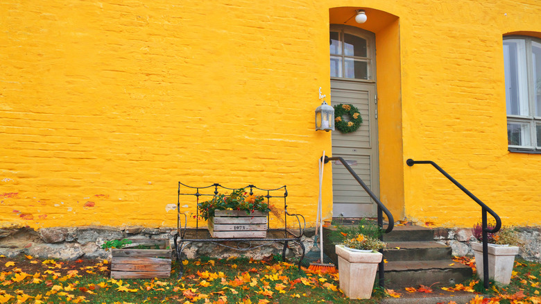 yellow house with wood crate