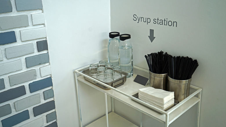 cart with coffee and stirrers