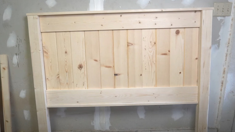 A handmade wooden headboard made from fencing