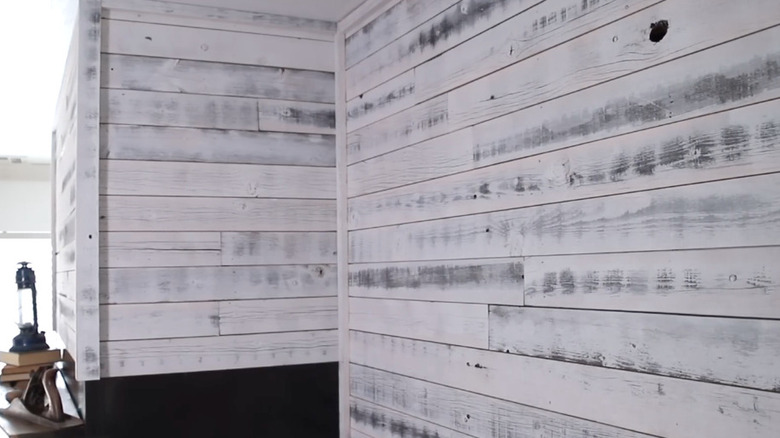 White washed wall paneling made from old fence posts