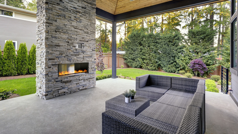 concrete slab patio with outdoor fireplace