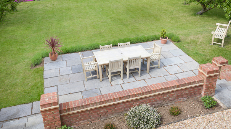 concrete tile patio with wood furniture