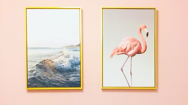 Beach scene and flamingo art on wall