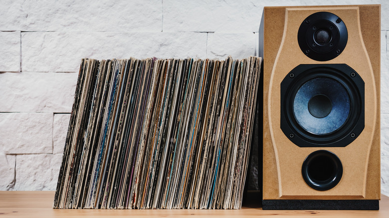 records leaning against tan speaker