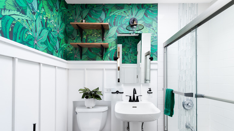 white bathroom with green wallpaper