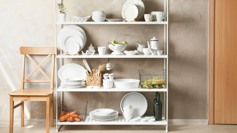 Storage stand with white kitchenware indoors