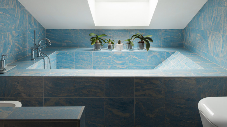 bathtub with large blue tiles