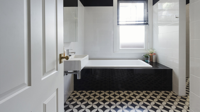 bathroom with a black tub