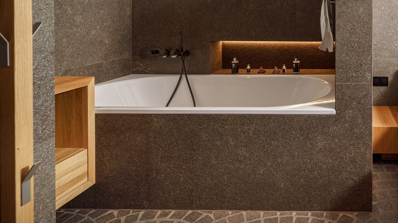 bathtub with stone-like surround