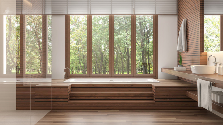 bathroom with wood bathtub surround