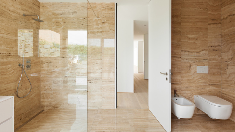 doorless bathroom shower with marble tiles