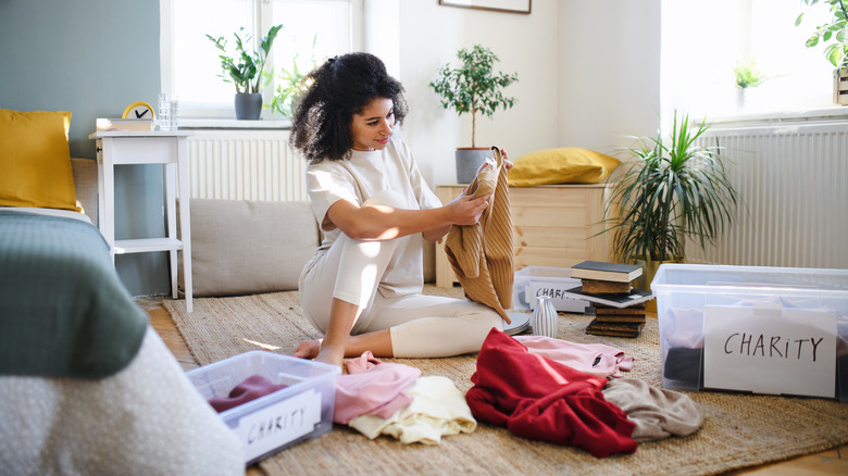 woman sorting clothes for donation