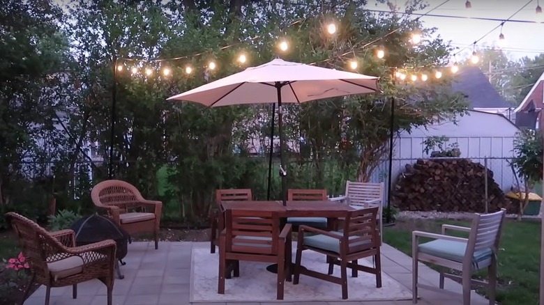 patio with lights seating and umbrella
