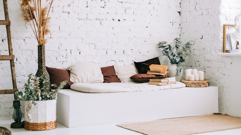 large white bench with pillows