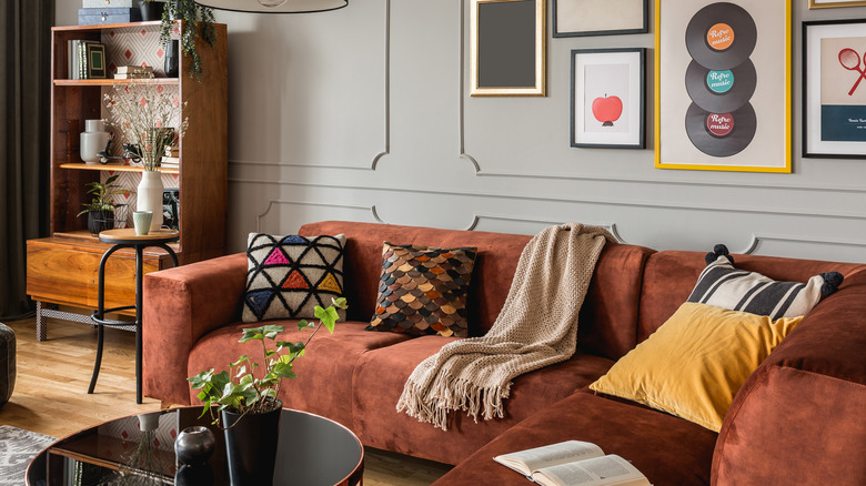 orange couch with patterned pillows