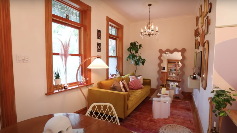 yellow couch with pink rug