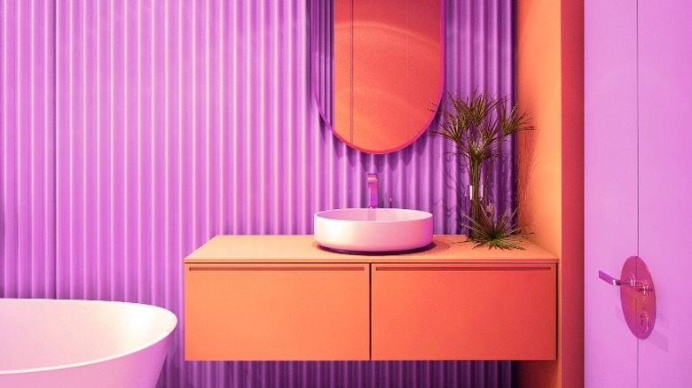 Purple bathroom with coral cupboards