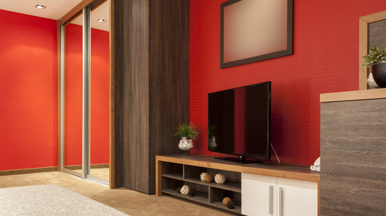 orangey-red room with a TV