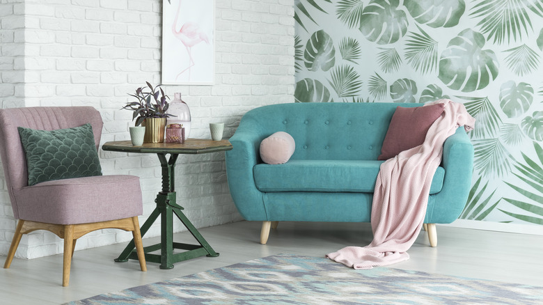 green leaf wallpaper behind couch