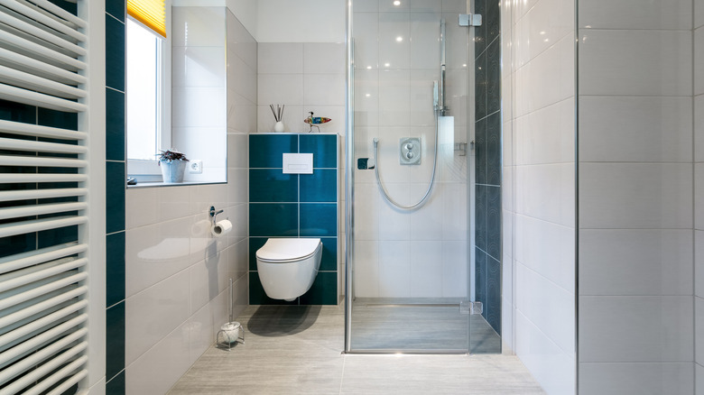 Navy blue tile toilet backsplash