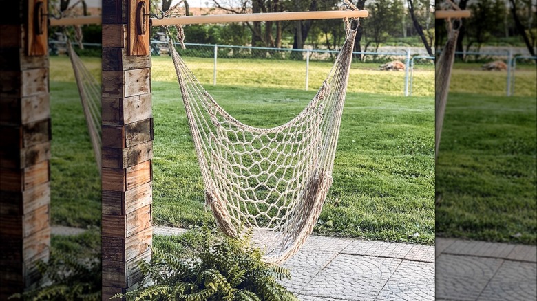 White hammock hanging above tiny patio