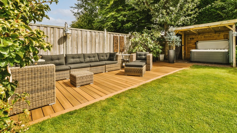 Small patio with wooden planks and sofa seating