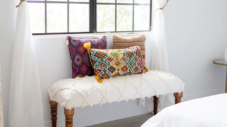 Colorful pillows on white bench