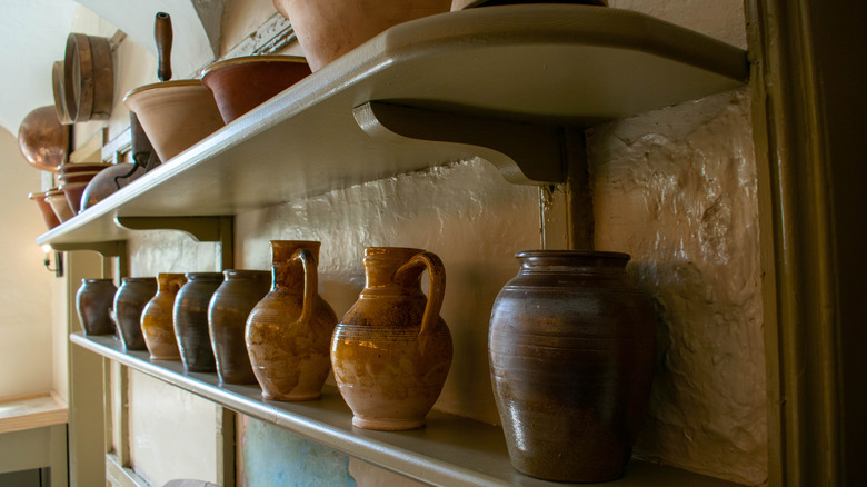 Terracotta pots on shelf