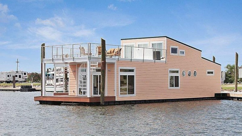 Pink houseboat with large upper deck