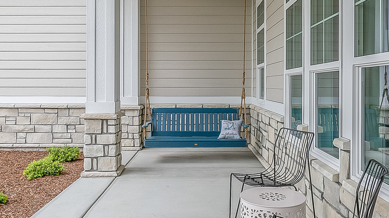 blue hanging bench on porch