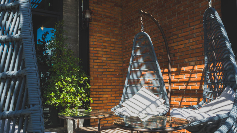 blue-gray egg chairs on porch