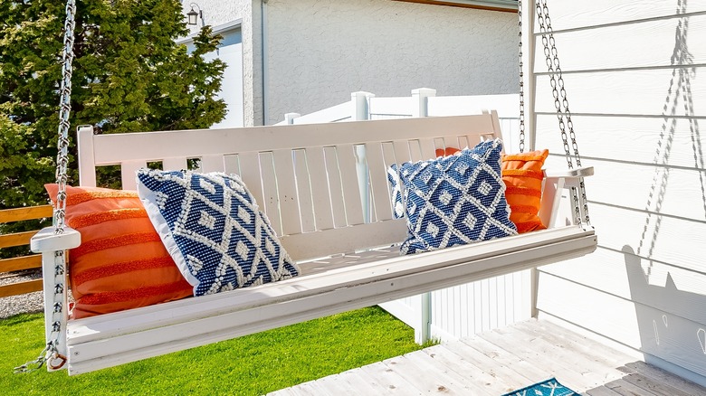 white front porch hanging bench